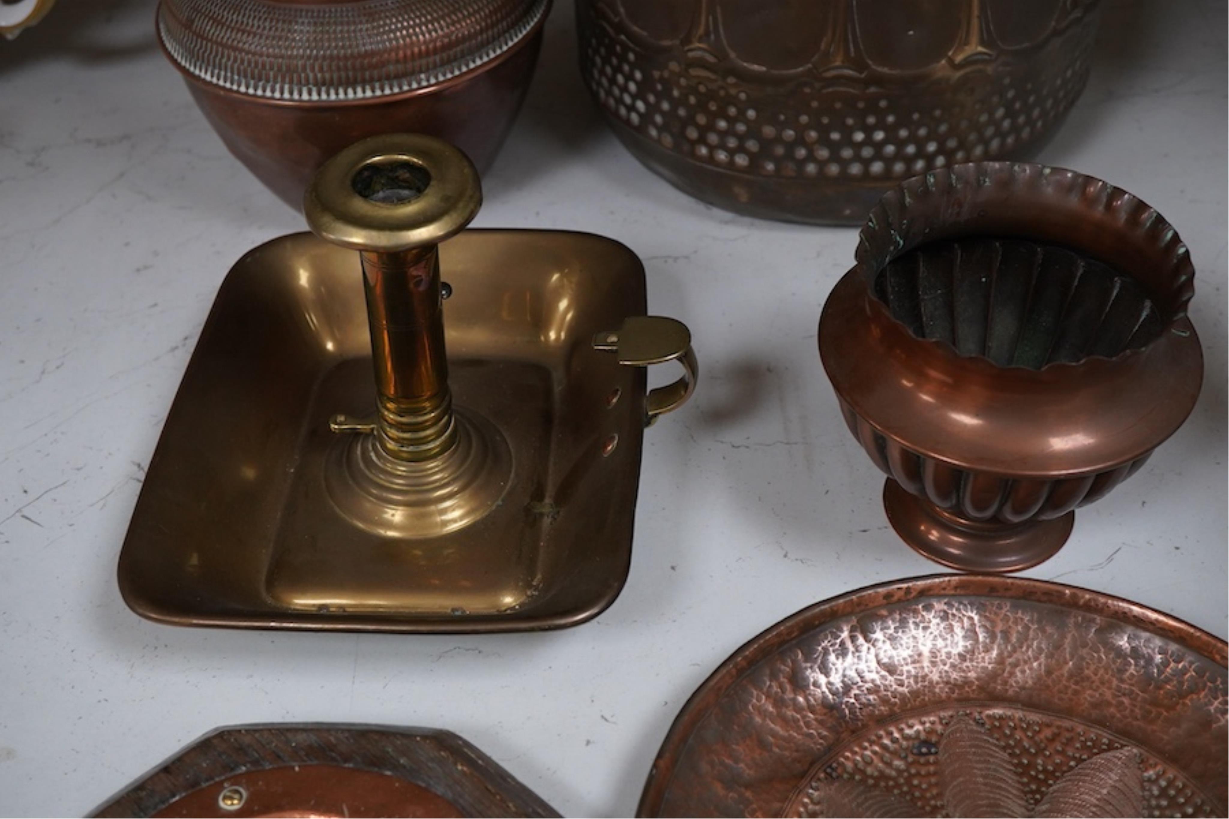 A group of brass and copper Arts & Crafts vases, including a J Sankey leaf candle holder